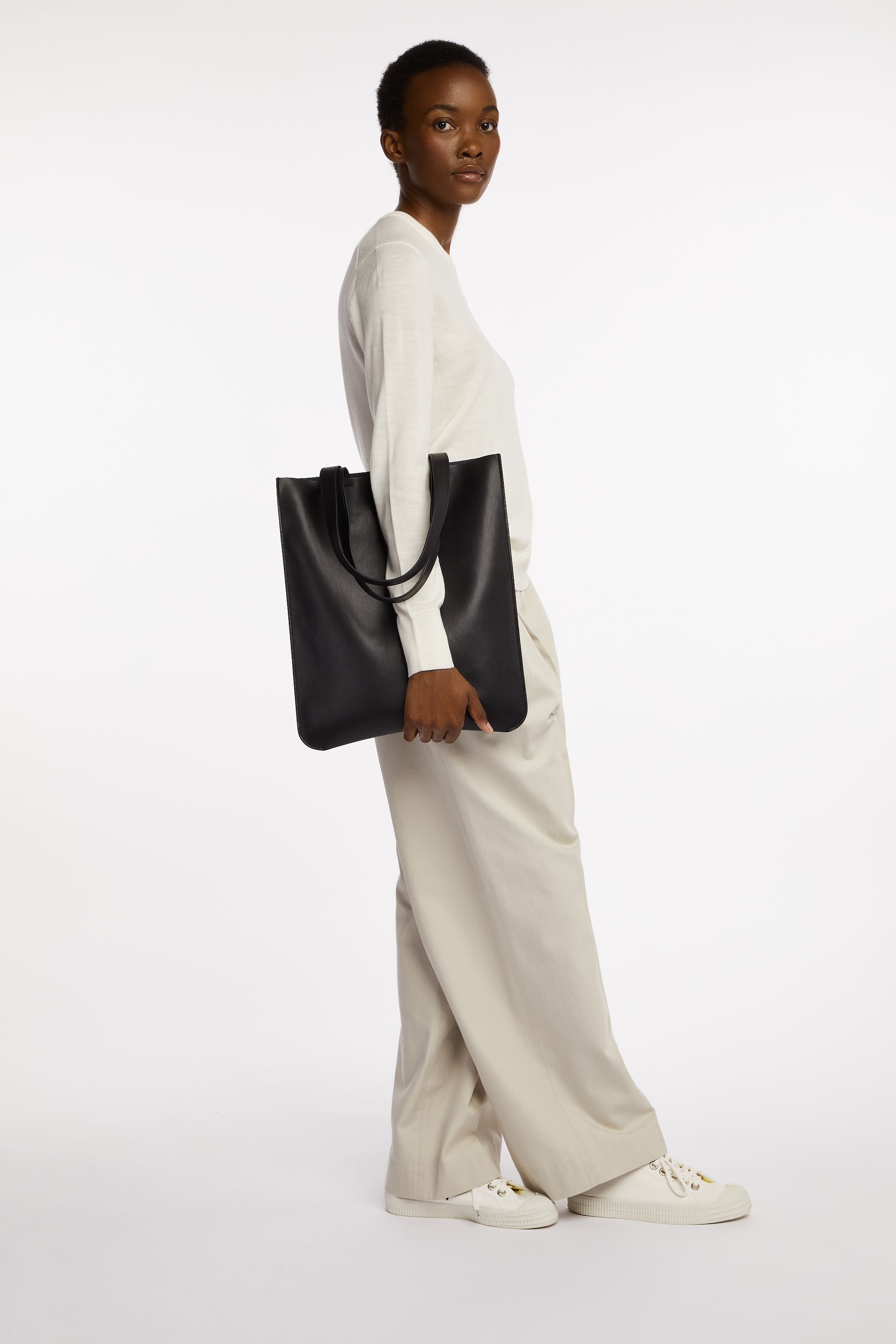 New East Tote In Black Onyx held by model