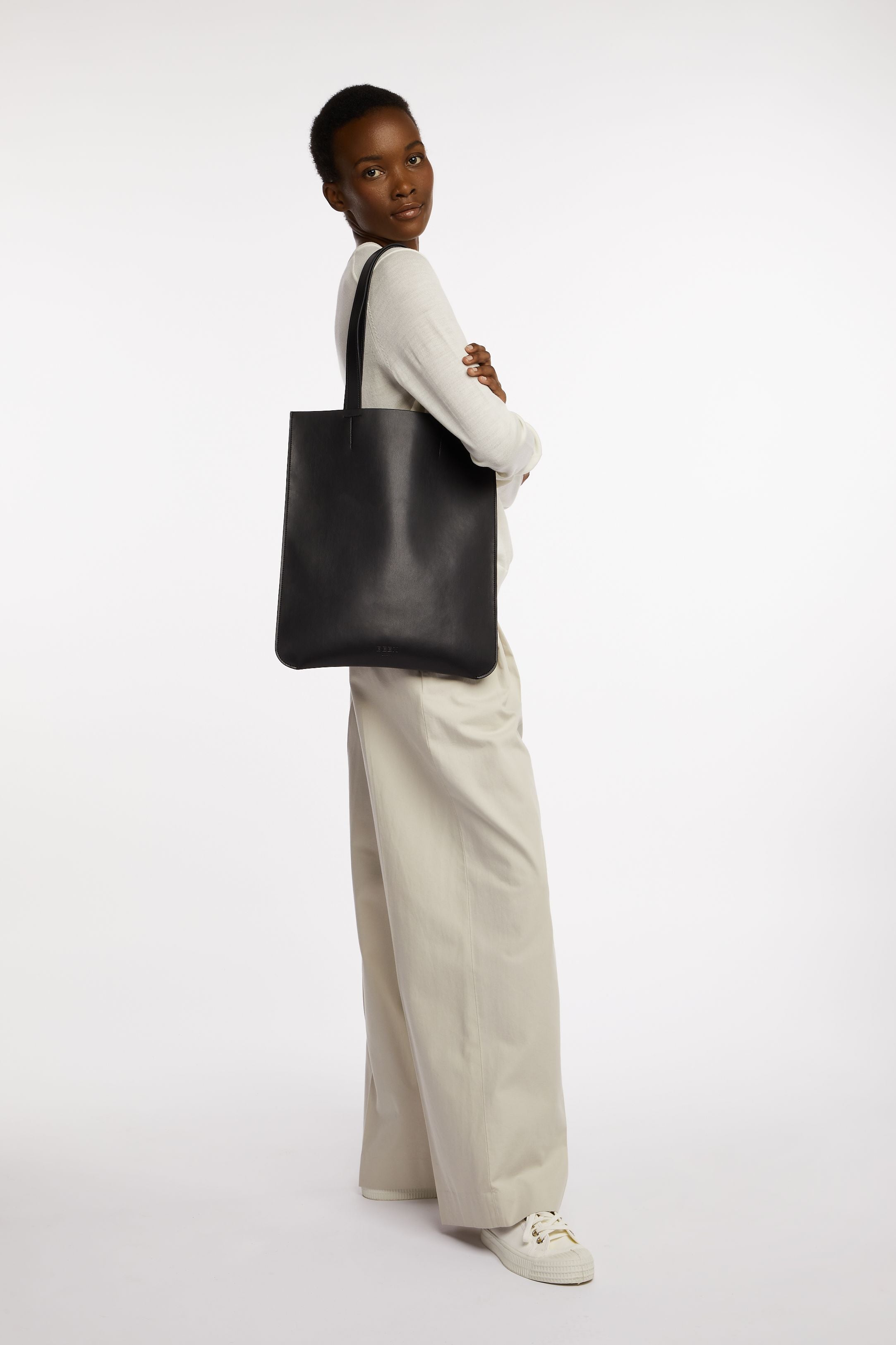 New East Tote In Black Onyx on model's shoulder