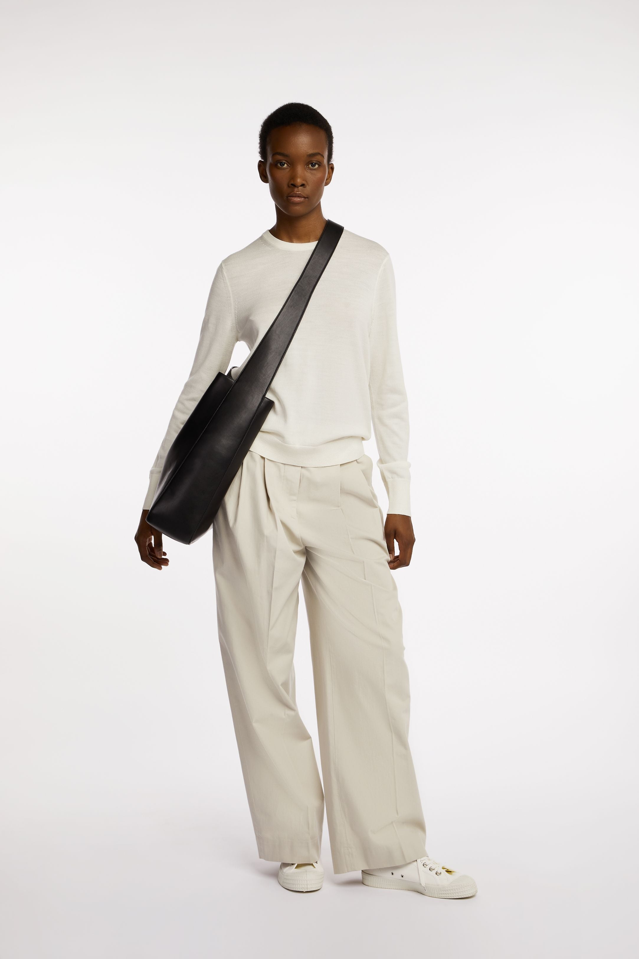 Rowe Tote in Black Onyx on model as a sling front view
