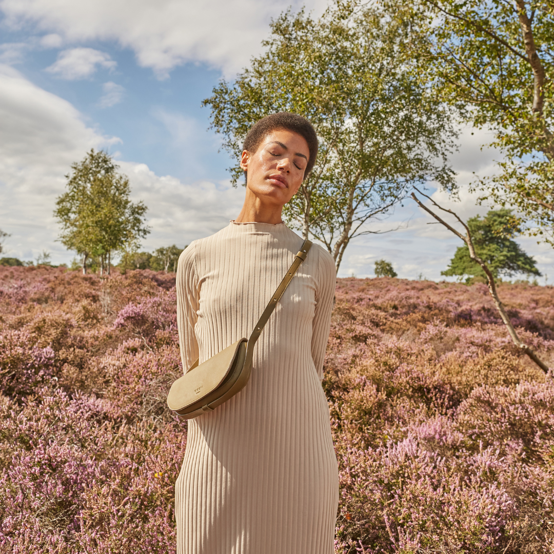 Our Mini Millais bag in recycled leather worn by model in nature background