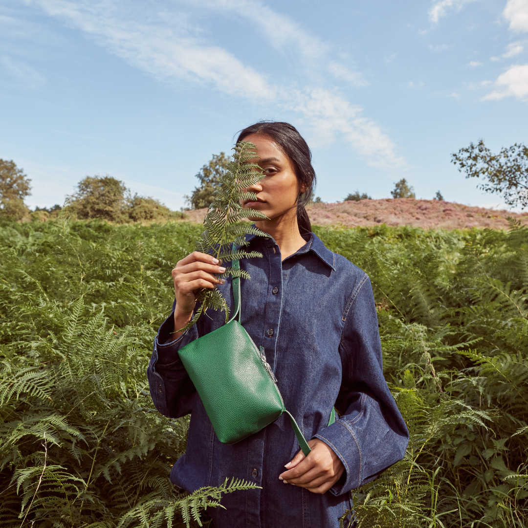 Rees Recycles pebbled leather Crossbody in Rainforest Green on model