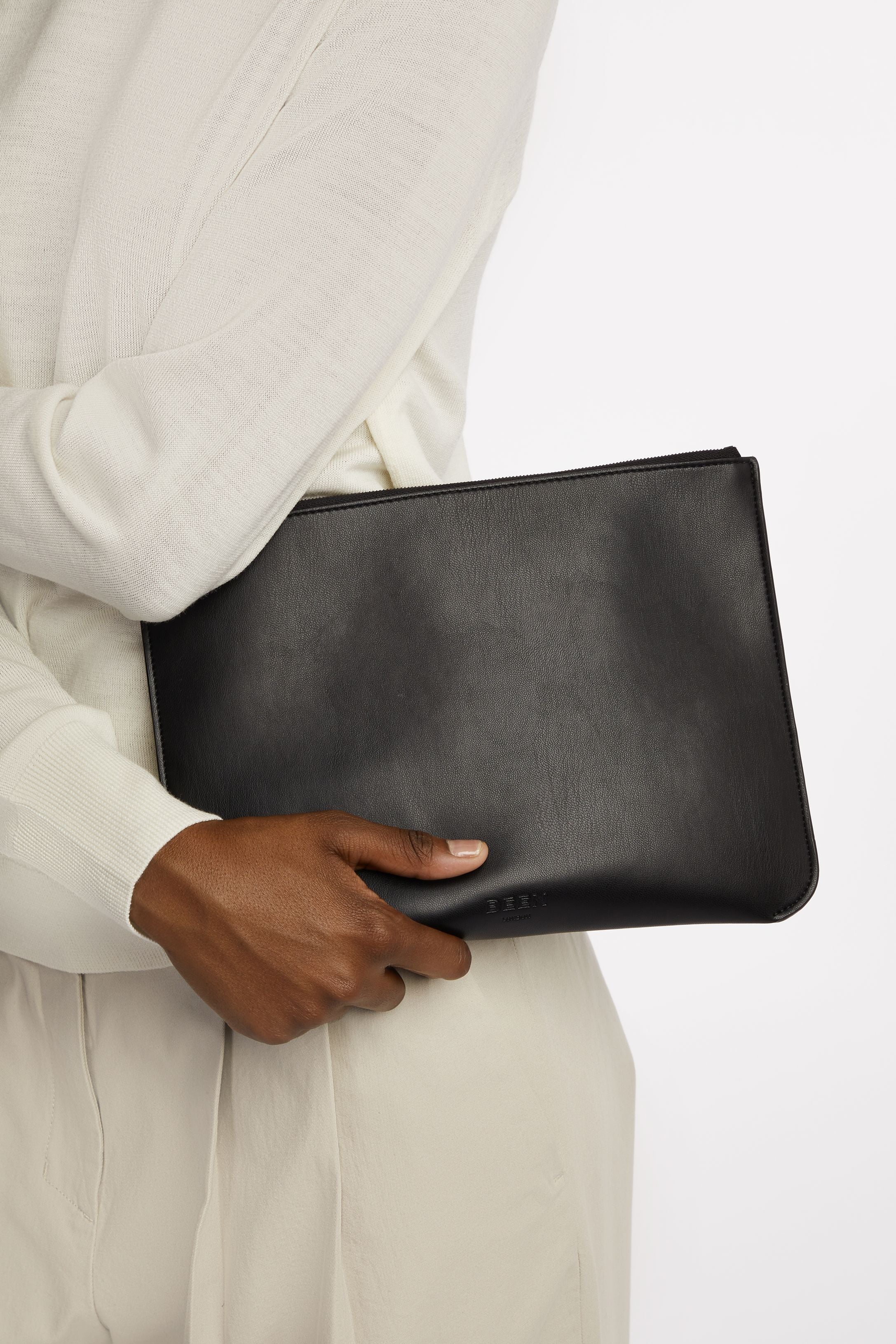 Yael Clutch bag- Medium Pouch in Black Onyx held by model close up 