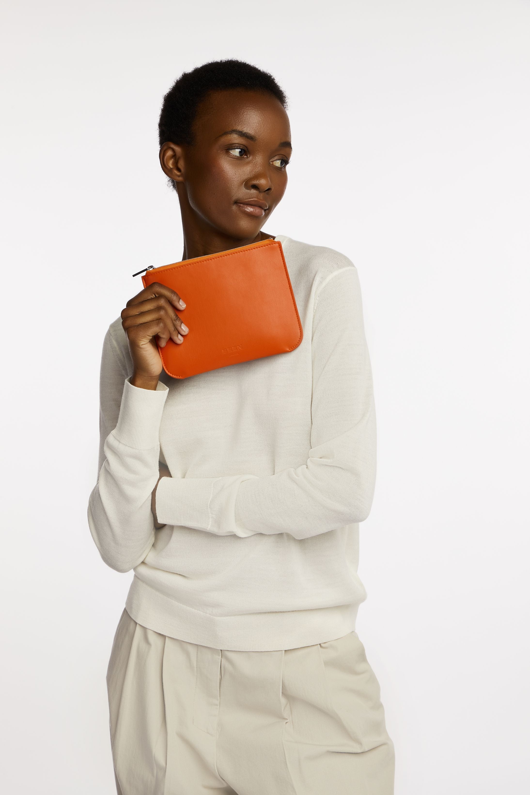 Daley Small Pouch in Blood Orange held by model