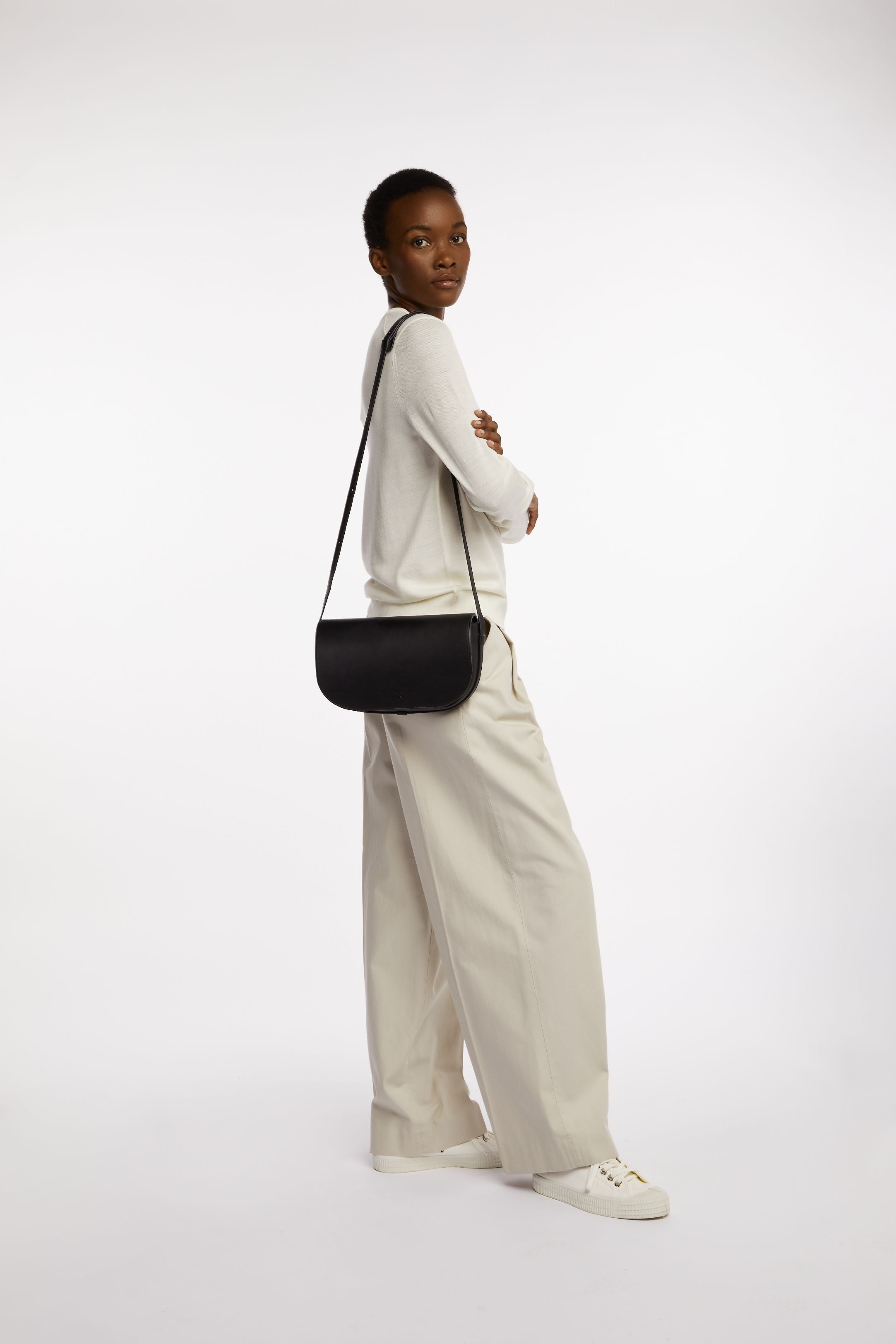 Millais Bag in Black Onyx on model as shoulder bag on longest strap